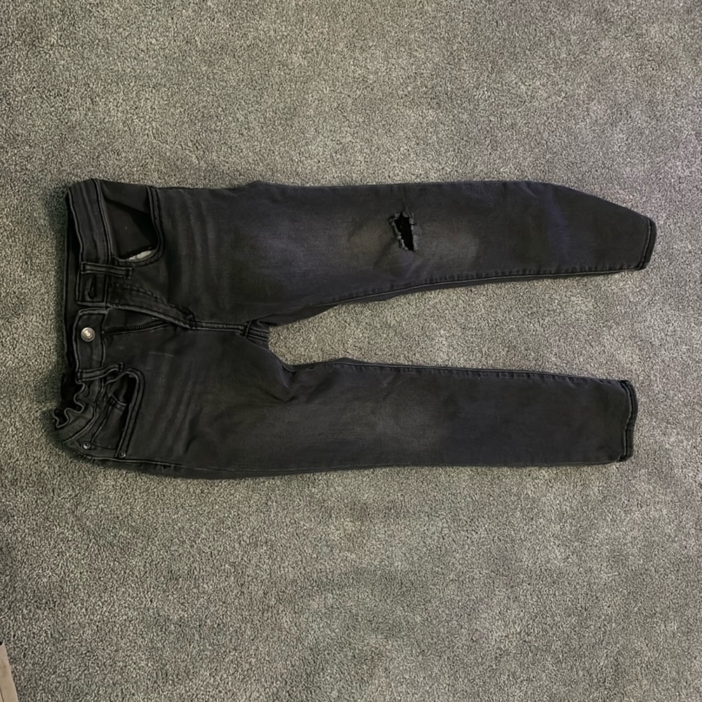 Blackish jeans, one knee rip on left side